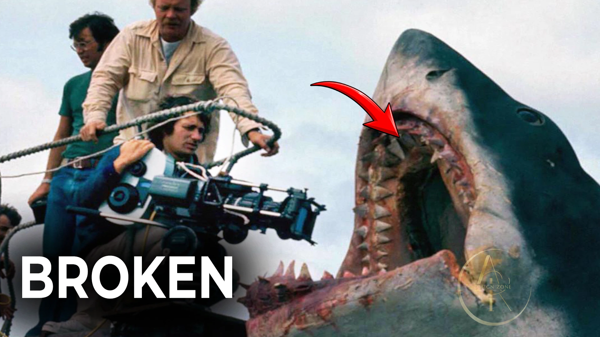Film crew beside a damaged mechanical shark, with BROKEN in bold white text.